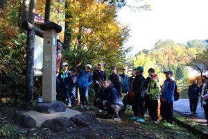 建立された石碑の前で、宇津峠の歴史の講話を聴く子どもたち